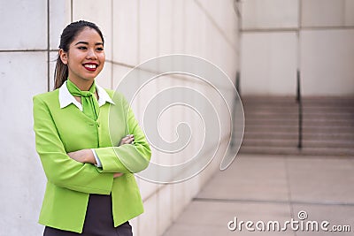 Young scort woman or crew smiling crossed arms green Stock Photo