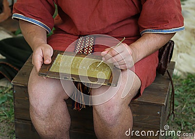 Young SCRIBE writes on a wax Tablet Stock Photo