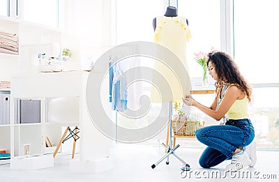 Seamstress hemming dress on mannequin Stock Photo