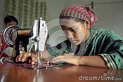 Young seamstress is working with sewing machine Editorial Stock Photo