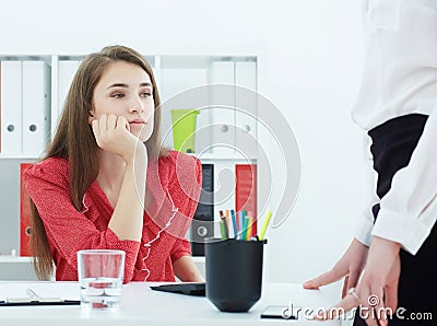 Young tired secretary listening to its director. Concept of excessive workload. Stock Photo