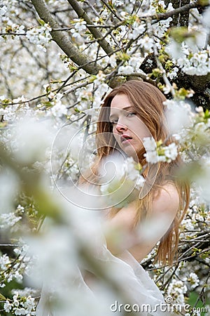 young seductive beauty redhead woman portrait, spring positive emotions in blooming apple tree blossoms Stock Photo