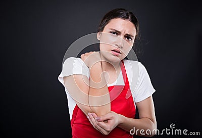 Young seller with elbow pain Stock Photo