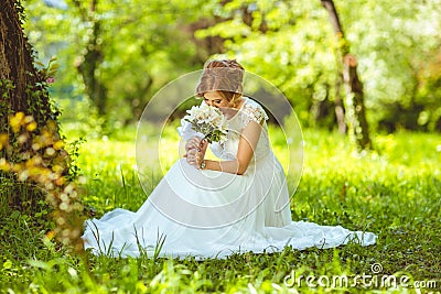 Young sensual bride sitting in a summer Stock Photo