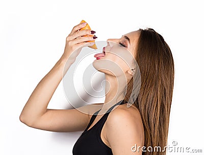 Young sensual woman with grapefruit in her hands, girl is eating grapefruit Stock Photo