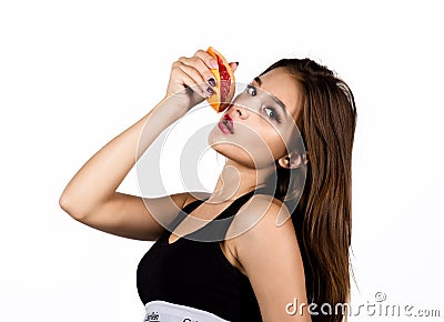 Young sensual woman with grapefruit in her hands, girl is eating grapefruit Stock Photo