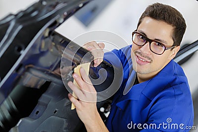 Young service mechanic cleaning automobile car door Stock Photo