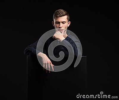 Young man showing presentation, pointing on placard Stock Photo