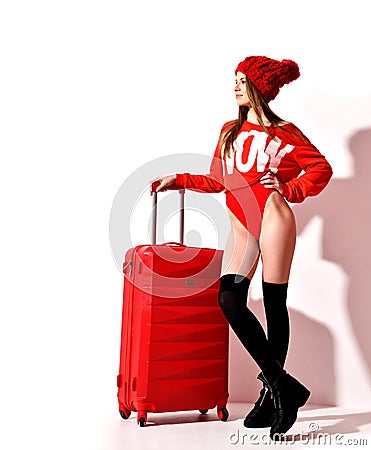 Young woman in fashion red body cloth and hat with traveler luggage bag on white Stock Photo