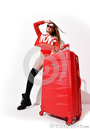 Young woman in fashion red body cloth and hat with traveler luggage bag on white Stock Photo