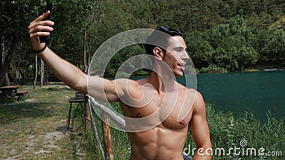 Man doing videochat at lake Stock Photo