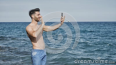 Handsome man doing videochat at sea Stock Photo