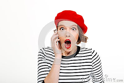 Young shocked woman talking by mobile phone Stock Photo