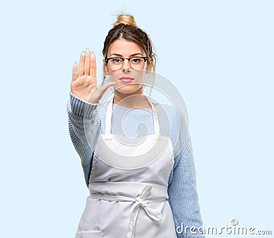 Young shop owner woman wearing apron Stock Photo