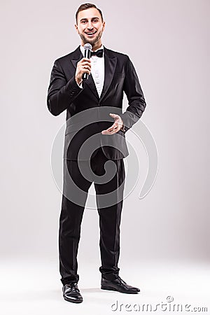 Young Showman presenter with microphone against white background. Stock Photo