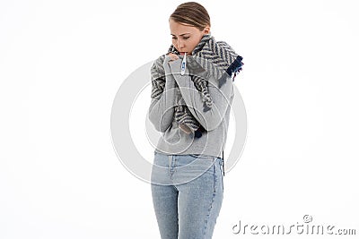 Young sick woman wrapped in a scarf. Cold, flu, illness Stock Photo