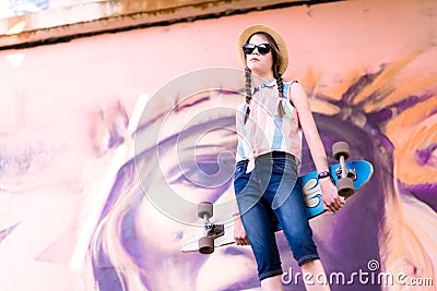 Young skateboard girl holding her longboard outdoors Editorial Stock Photo