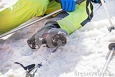 young skier rests on a snowy slope on a sunny day. school holidays. Stock Photo