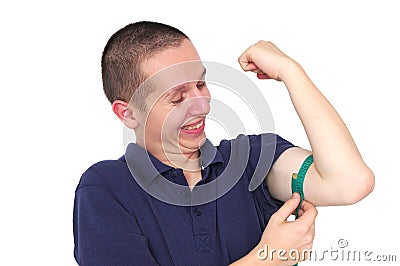 Young skinny man measuring his muscle Stock Photo