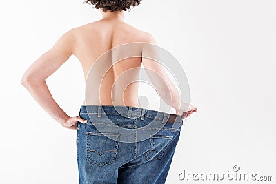 Young skinny man wearing oversized jeans Stock Photo