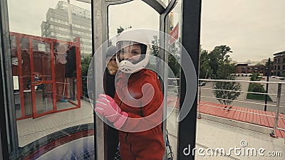 Young skydiver woman getting ready for flight in wind tunnel Stock Photo