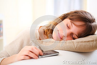 Young sleeping pretty girl waiting for a call Stock Photo