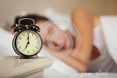 Young sleeping woman in bedroom. Stock Photo