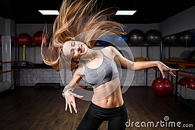 Young slim fitness girl with long waved hair Stock Photo