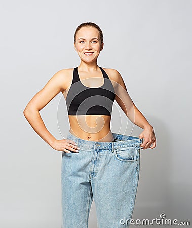 Young slim sporty woman in oversize pants Stock Photo