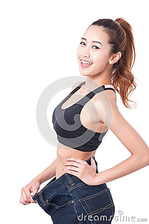 Young slim woman wearing too big jeans Stock Photo