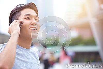 Young smart asian male teen calling phone call Stock Photo