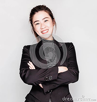 Young smart beautiful asian business woman wore black suit and glasses,smart and thinking holding Document, talking phone Stock Photo