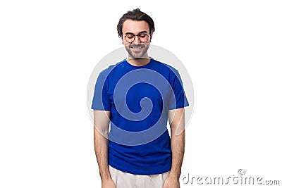 young smart caucasian man with dark well-groomed hair and a beard in a blue t-shirt on a white background Stock Photo