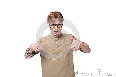 a young smart european male student with red golden hair dressed in a light brown shirt tells the news Stock Photo
