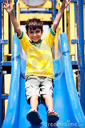 Young smart kid sliding down the swing Stock Photo