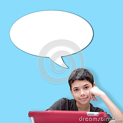 Young smiling boy with one hand resting on cheek with speech bubble against blue background Stock Photo