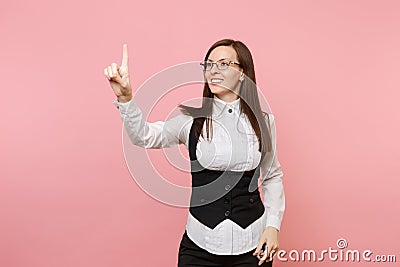 Young smiling business woman in glasses touch something like push on button, pointing at floating virtual screen Stock Photo