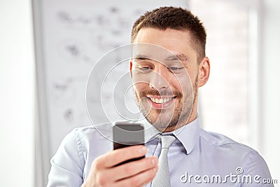 Young smiling businessman with smartphone Stock Photo