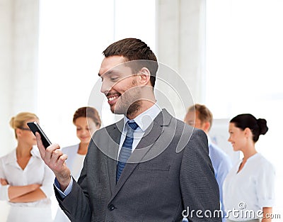 Young smiling businessman with smartphone Stock Photo