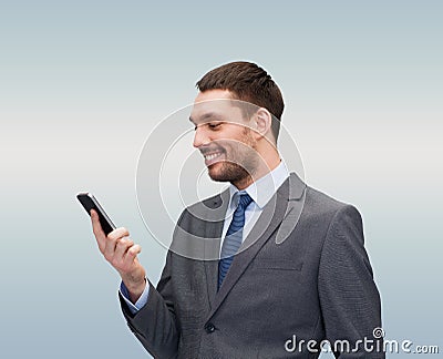 Young smiling businessman with smartphone Stock Photo