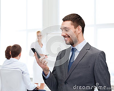 Young smiling businessman with smartphone Stock Photo