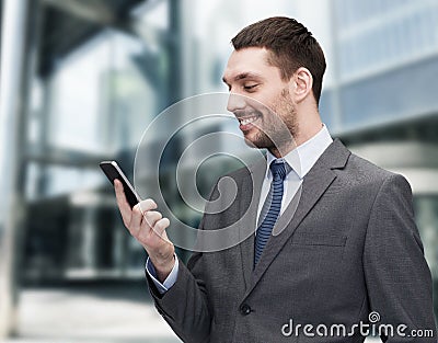 Young smiling businessman with smartphone Stock Photo