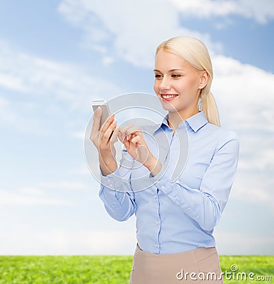 Young smiling businesswoman with smartphone Stock Photo