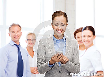 Young smiling businesswoman with smartphone Stock Photo