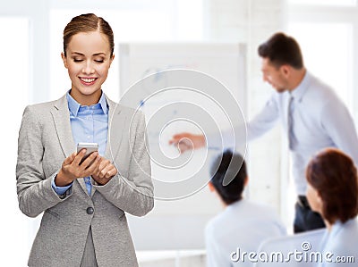 Young smiling businesswoman with smartphone Stock Photo