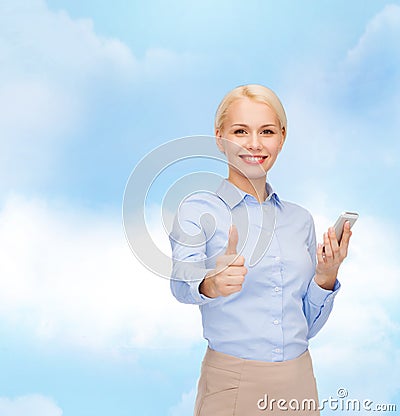 Young smiling businesswoman with smartphone Stock Photo