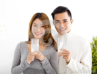 Young smiling couple drinking milk Stock Photo