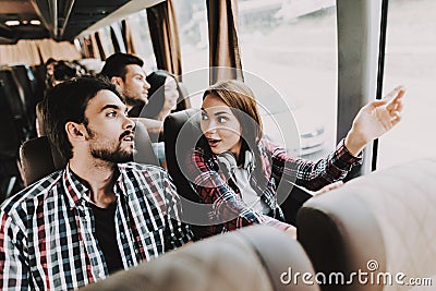 Young Smiling Couple Traveling on Tourist Bus Stock Photo