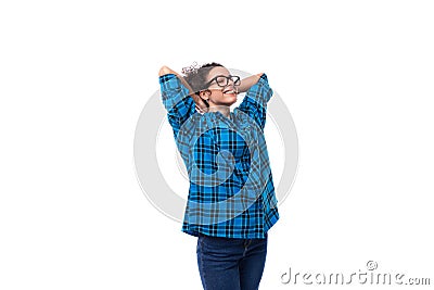 young smiling energetic curly european woman dressed casually in a blue plaid shirt on a white background Stock Photo