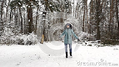 Young smiling girl recreation at snowy forest. Happy woman enjoying beautiful winter day at pine woodland. Cheerful lady Stock Photo